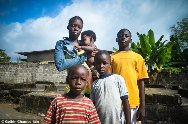 Pictured is Odell Kpaingba, 17, holding her brother Daniel, five months, next to her brothers (from left) Josiah, 5, Otis, 8 and Chancy, 15. The family are orphans after the Ebola virus claimed both their parents